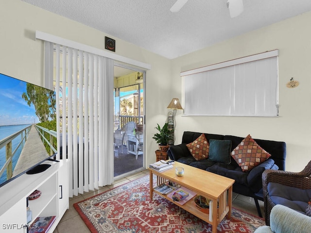 tiled living room featuring a textured ceiling