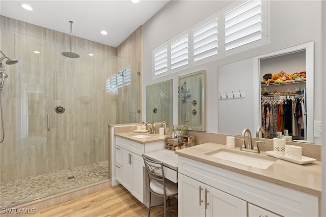 3967 Skyway Dr Unit 14, Naples, FL 34112 - full bathroom featuring a shower stall, double vanity, recessed lighting, a walk in closet, and wood finished floors