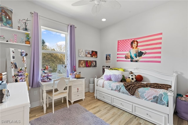 bedroom with light wood-type flooring, white fridge, and ceiling fan