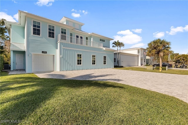 3967 Skyway Dr Unit 14, Naples, FL 34112 - view of front facade with a front lawn, decorative driveway, cooling unit, a balcony, and a garage