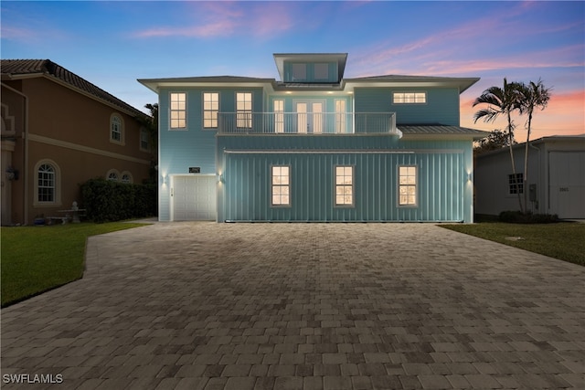 3967 Skyway Dr Unit 14, Naples, FL 34112 - coastal inspired home with a balcony, board and batten siding, decorative driveway, an attached garage, and a front lawn