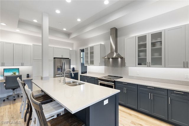 3967 Skyway Dr Unit 14, Naples, FL 34112 - kitchen with appliances with stainless steel finishes, wall chimney exhaust hood, a sink, a kitchen bar, and a center island with sink