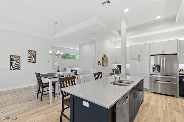 3967 Skyway Dr Unit 14, Naples, FL 34112 - kitchen with stainless steel appliances, a sink, light wood finished floors, a chandelier, and recessed lighting