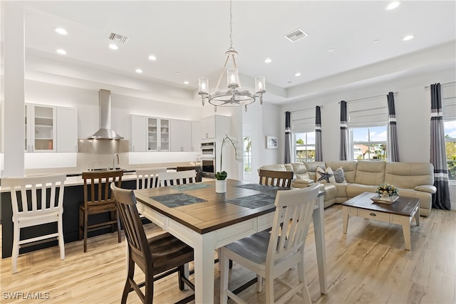 3967 Skyway Dr Unit 14, Naples, FL 34112 - dining room with a tray ceiling, a chandelier, light wood-style flooring, and recessed lighting