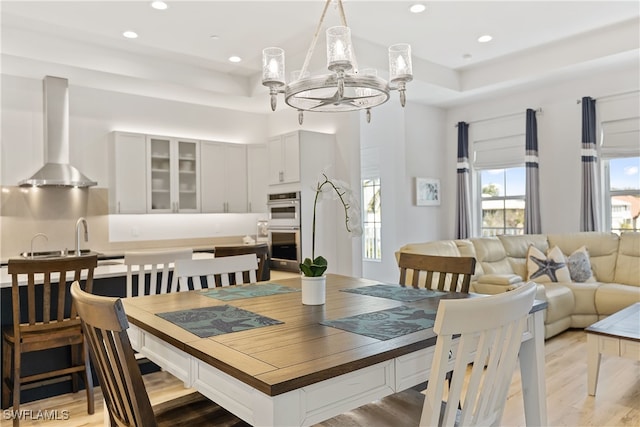 3967 Skyway Dr Unit 14, Naples, FL 34112 - dining area with a chandelier, light wood-style flooring, recessed lighting, and a tray ceiling