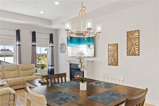 dining room featuring hardwood / wood-style flooring and a notable chandelier