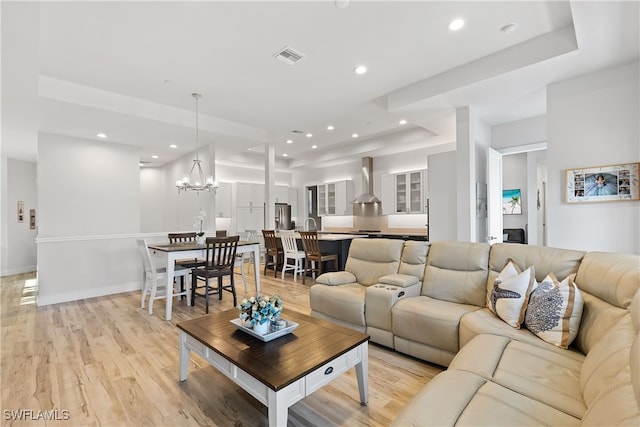 3967 Skyway Dr Unit 14, Naples, FL 34112 - living room with a chandelier, light wood-style flooring, recessed lighting, and a raised ceiling