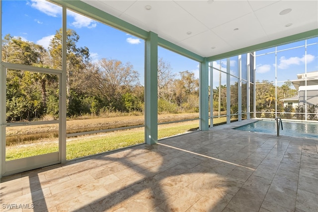 3967 Skyway Dr Unit 14, Naples, FL 34112 - unfurnished sunroom featuring view of scattered trees