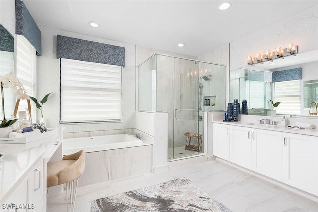 bathroom featuring vanity and independent shower and bath