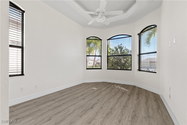 unfurnished room with light hardwood / wood-style flooring, plenty of natural light, ornamental molding, and ceiling fan