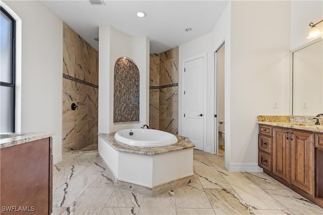 full bathroom with vanity, separate shower and tub, and toilet