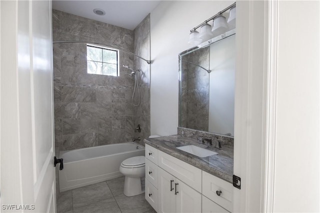 full bathroom featuring tile patterned floors, vanity, toilet, and tiled shower / bath