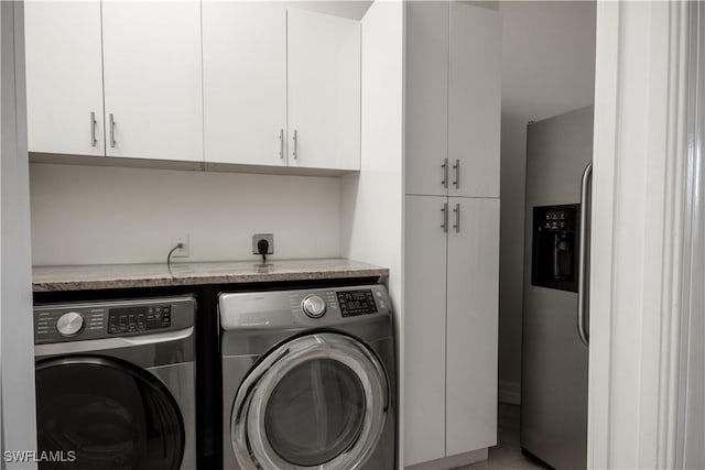 laundry room with washing machine and clothes dryer