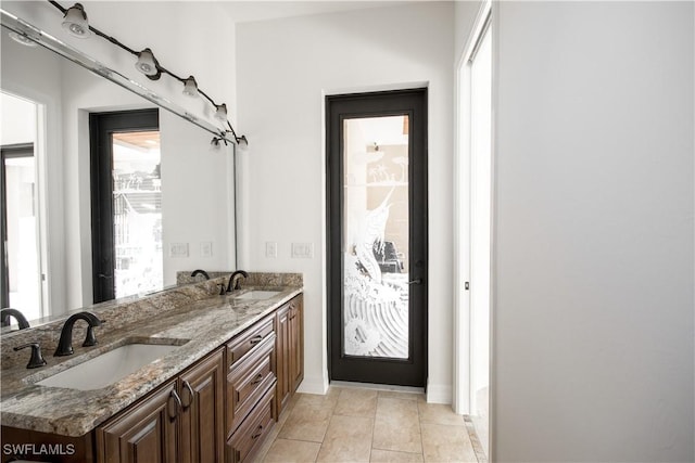 bathroom with tile patterned flooring, vanity, and plenty of natural light