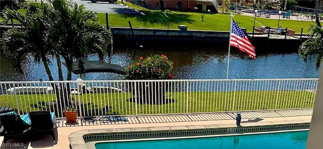 view of pool featuring a water view, fence, and a fenced in pool