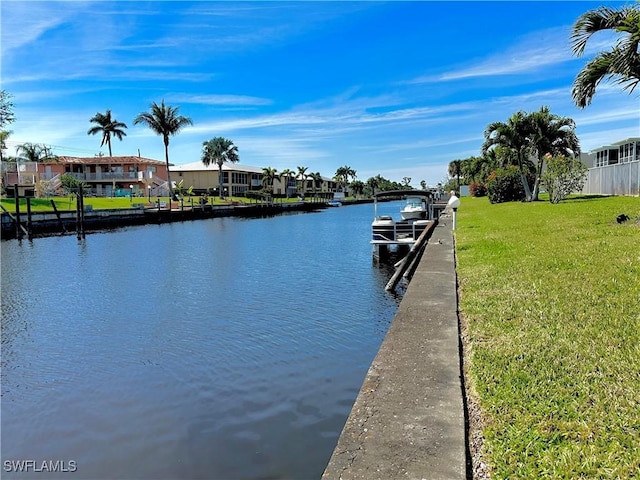 dock area with a residential view, a water view, and a lawn