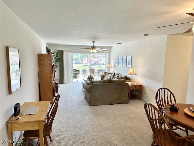 carpeted living room with ceiling fan