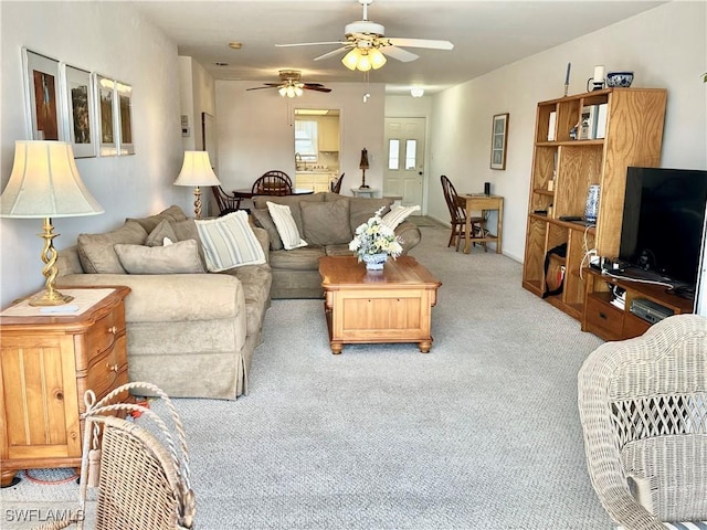 living room with a ceiling fan and light colored carpet