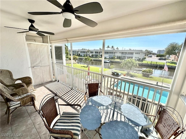 928 SE 46th St Unit 2C, Cape Coral, FL 33904 - sunroom / solarium with a ceiling fan, a water view, and a healthy amount of sunlight