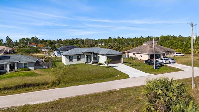 view of front of house featuring a front lawn and a garage