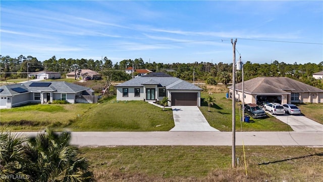 view of front of house with a front lawn and a garage