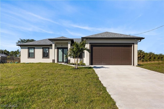 view of front of home with a front yard and a garage