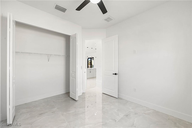 unfurnished bedroom featuring ceiling fan and a closet