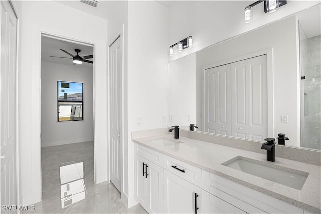 bathroom with ceiling fan, a shower with shower door, and vanity