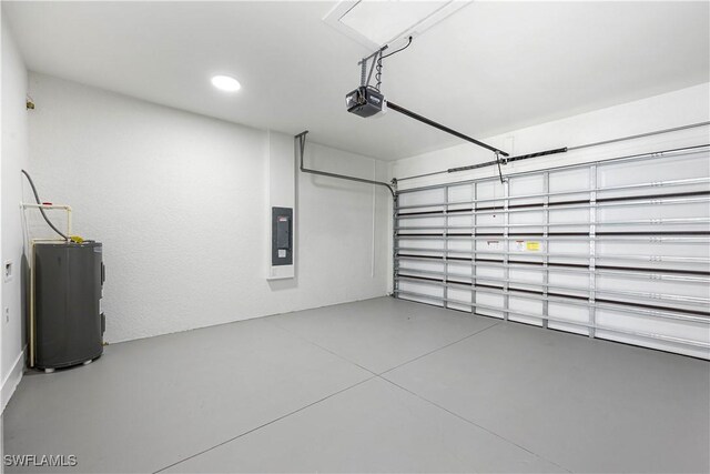 garage featuring a garage door opener, electric panel, and electric water heater