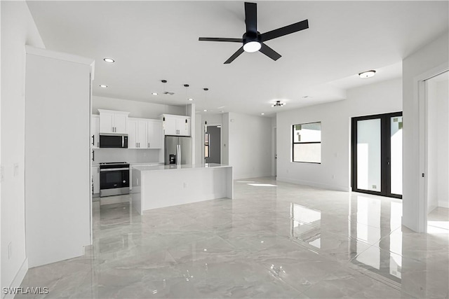 unfurnished living room featuring ceiling fan