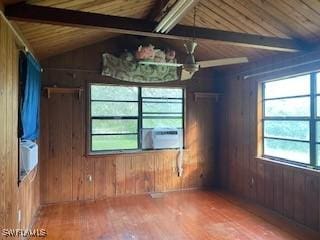 unfurnished room with wooden ceiling, wooden walls, vaulted ceiling with beams, and cooling unit