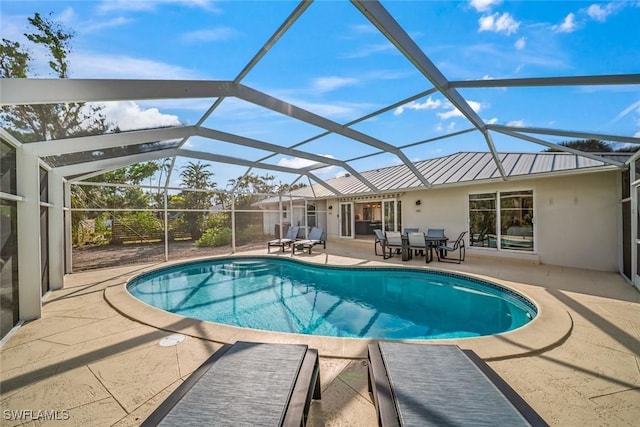 outdoor pool featuring a patio area and glass enclosure