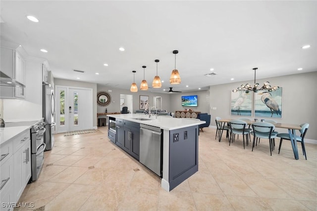 kitchen with stainless steel appliances, recessed lighting, light countertops, and a sink