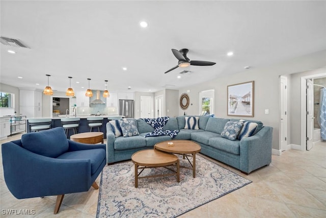 living area featuring visible vents, a ceiling fan, and recessed lighting