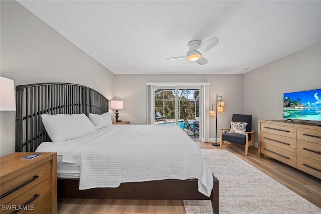 bedroom featuring access to outside, light wood finished floors, and a ceiling fan