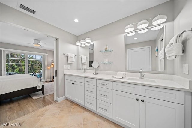 ensuite bathroom featuring double vanity, baseboards, visible vents, ensuite bathroom, and a sink