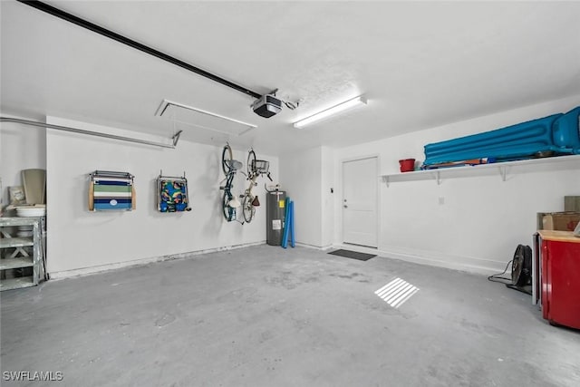 garage with water heater and a garage door opener