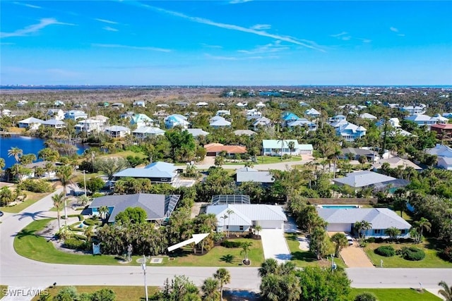 bird's eye view featuring a water view and a residential view