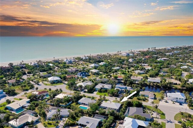 aerial view at dusk with a residential view and a water view