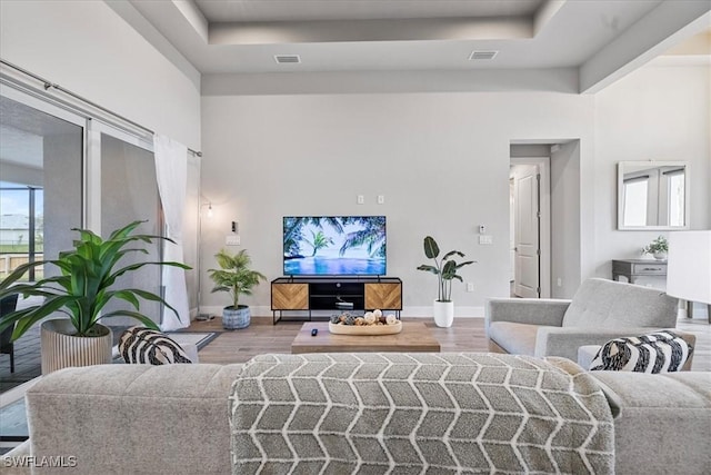 1142 SW 15th St, Cape Coral, FL 33991 - living area featuring wood finished floors, baseboards, and a raised ceiling