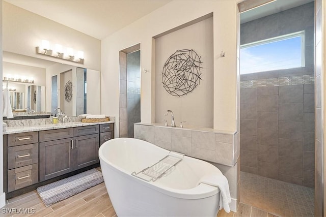 1142 SW 15th St, Cape Coral, FL 33991 - full bathroom featuring a freestanding bath, vanity, wood finished floors, and a walk in shower