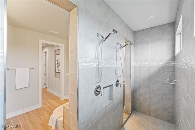 1142 SW 15th St, Cape Coral, FL 33991 - bathroom with walk in shower, wood finished floors, and baseboards
