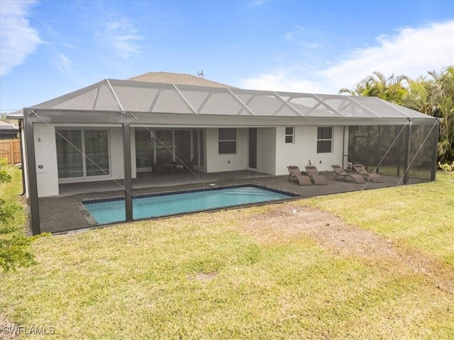 rear view of house with a patio area, a lanai, and a yard