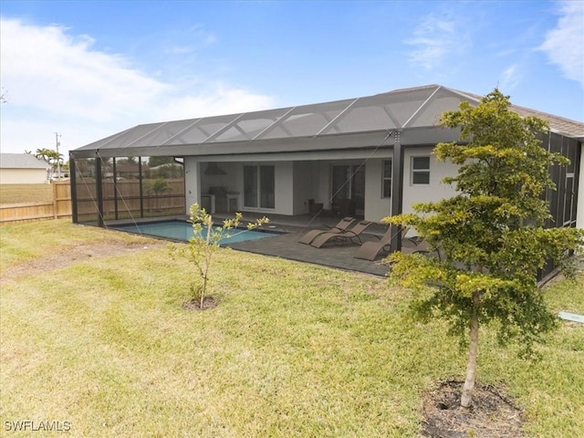 back of property with a lanai, a yard, a patio, and a fenced in pool