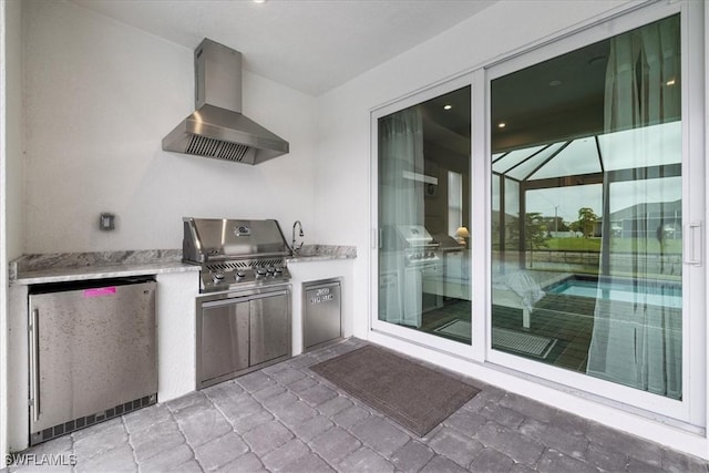 view of patio with an outdoor kitchen and area for grilling