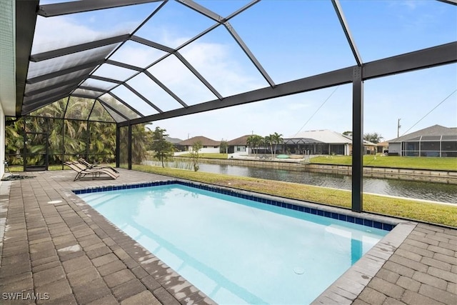 view of swimming pool with a patio, a water view, and glass enclosure