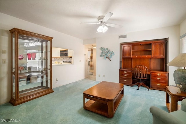 carpeted office space with ceiling fan