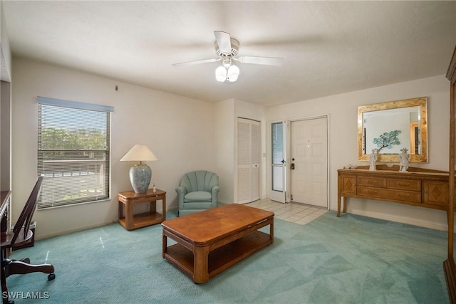 living area featuring ceiling fan and light carpet