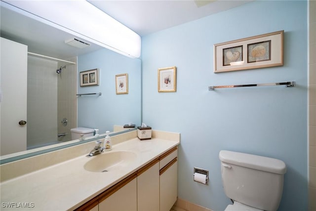 full bathroom featuring vanity, toilet, and tiled shower / bath