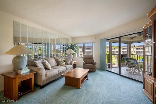 carpeted living room featuring ceiling fan